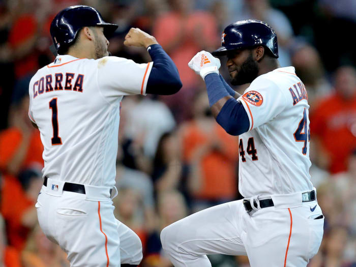 Aug 21, 2021; Houston, Texas, USA; Houston Astros designated hitter Yordan Alvarez (44, right) is congratulated by Houston Astros shortstop Carlos Correa (1, left) after hitting a three-run home run against the Seattle Mariners during the third inning at Minute Maid Park.